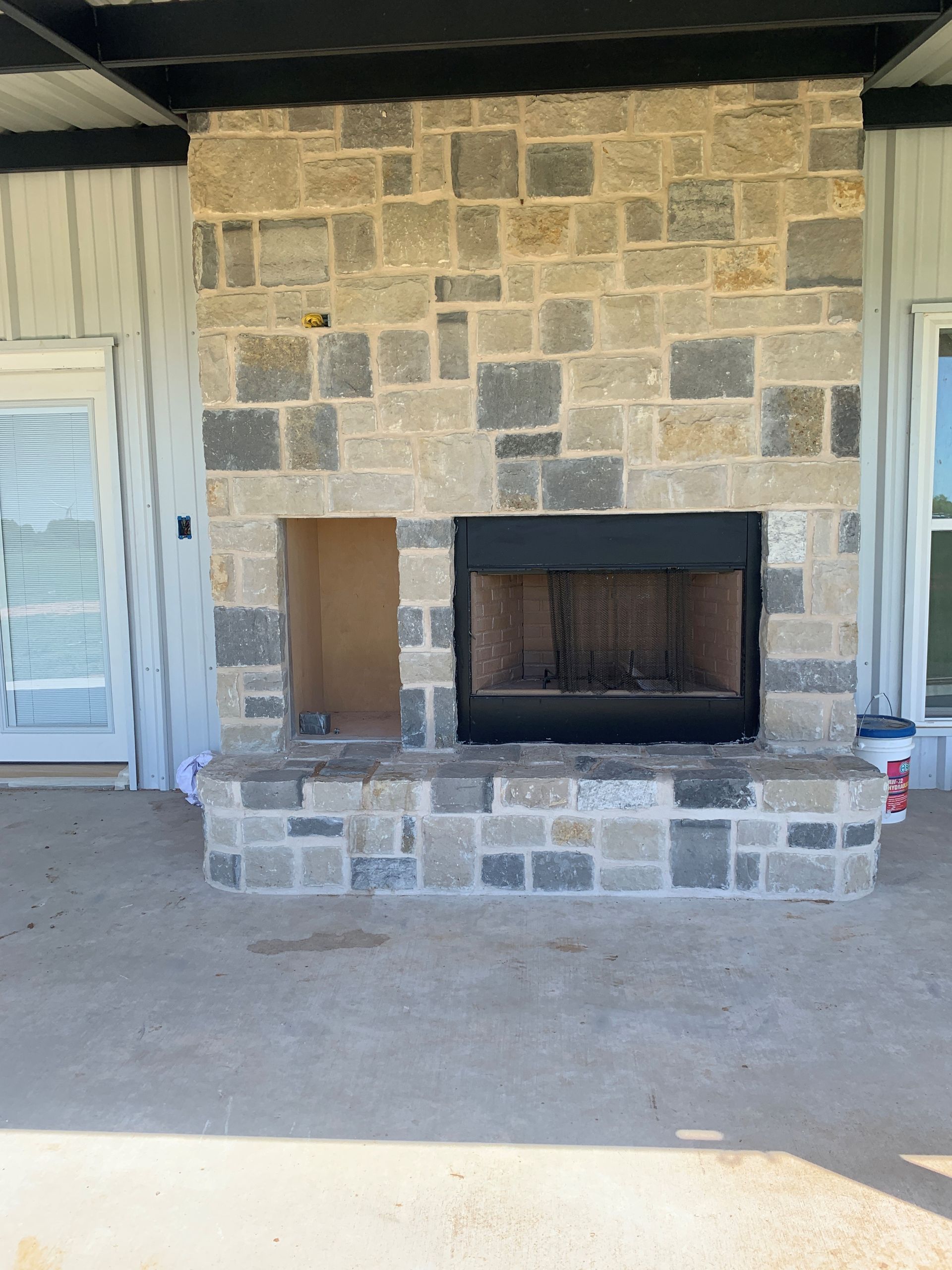A stone fireplace with a hole in the middle of it