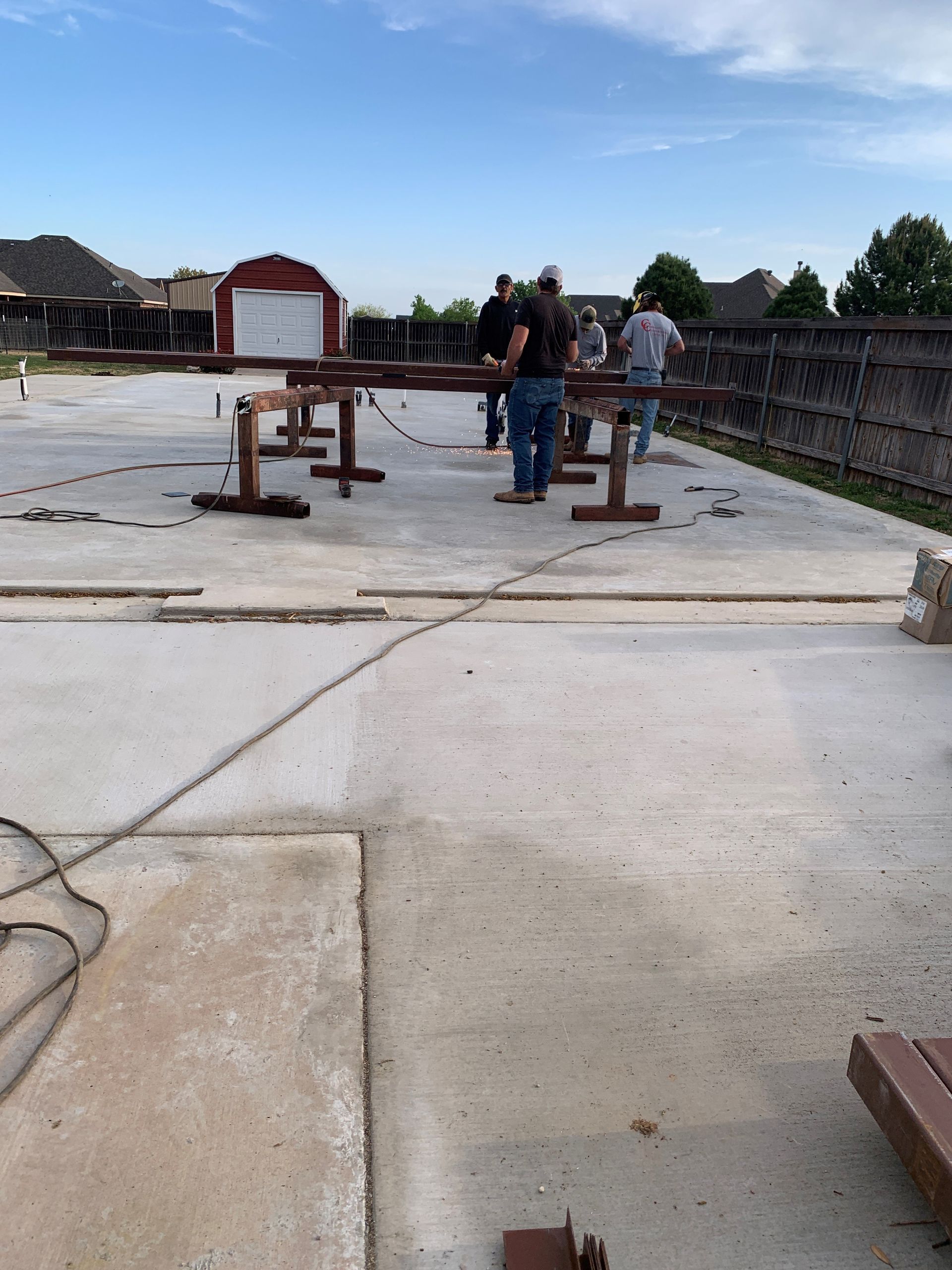 A group of people are working on a concrete surface