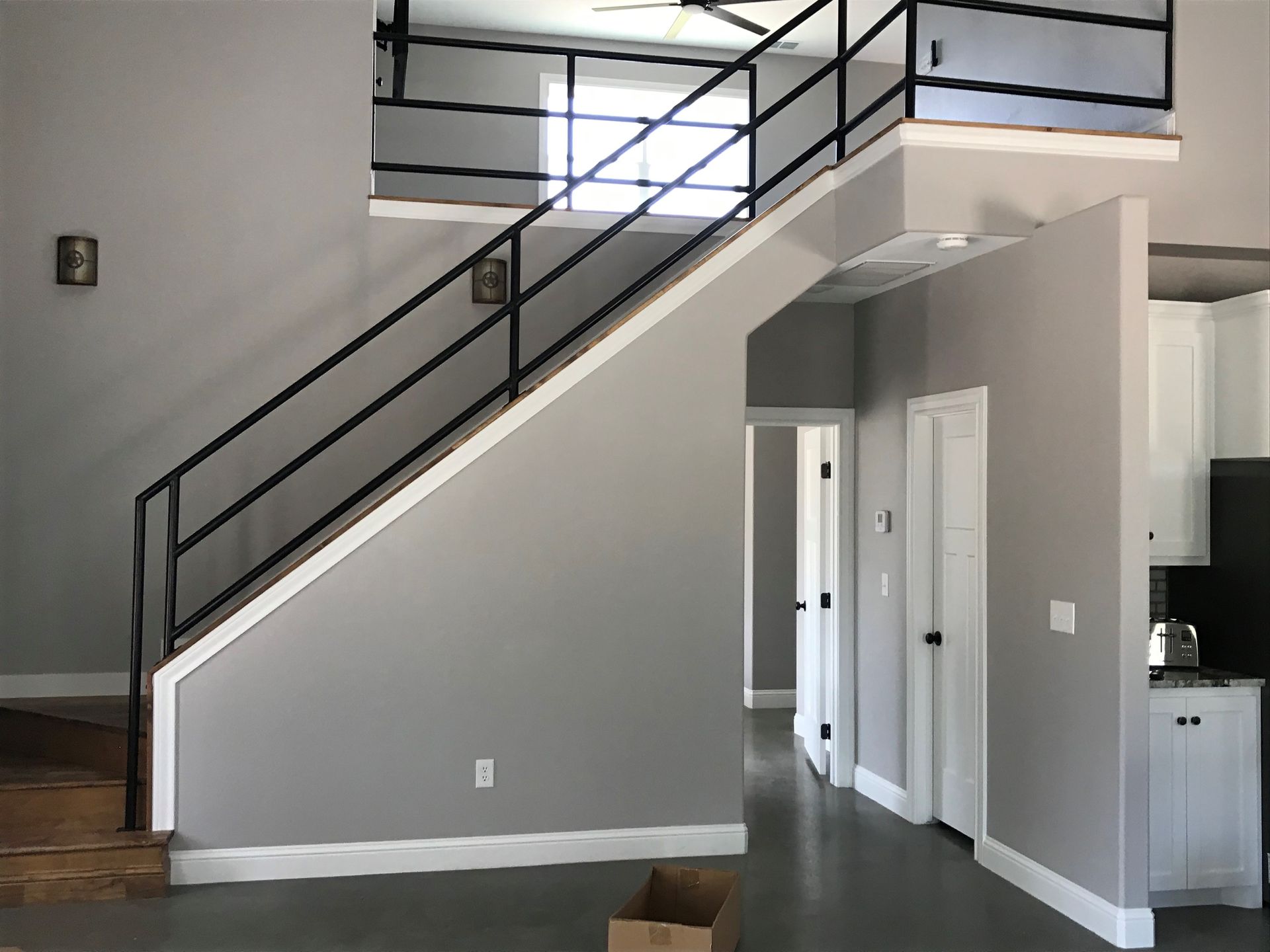 A living room with stairs leading up to the second floor