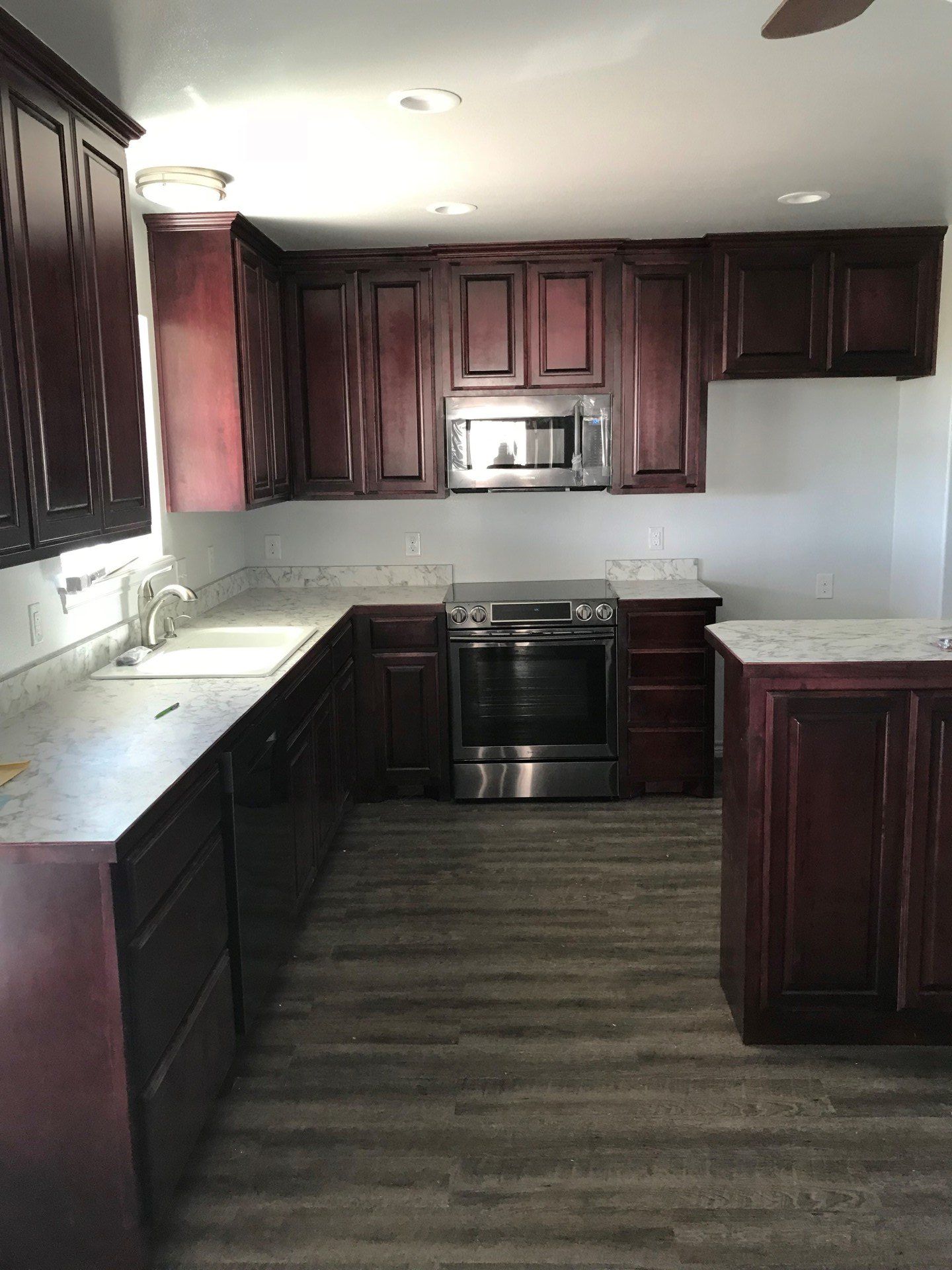 A kitchen with stainless steel appliances and wooden cabinets
