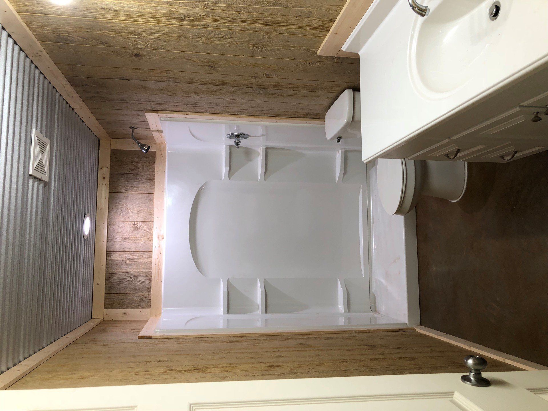 A bathroom with a toilet , sink and bathtub.