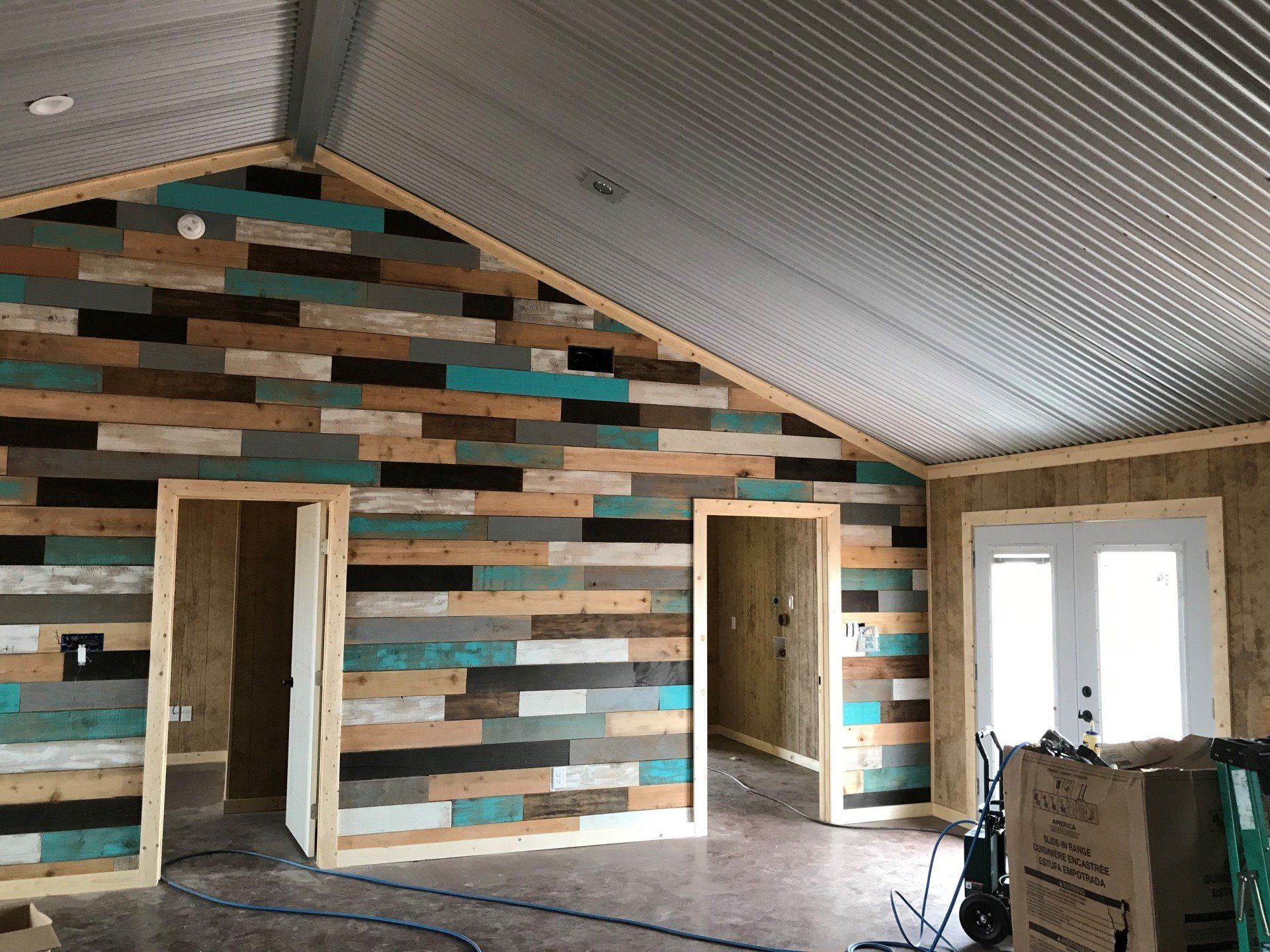 A room with a vaulted ceiling and wooden walls.