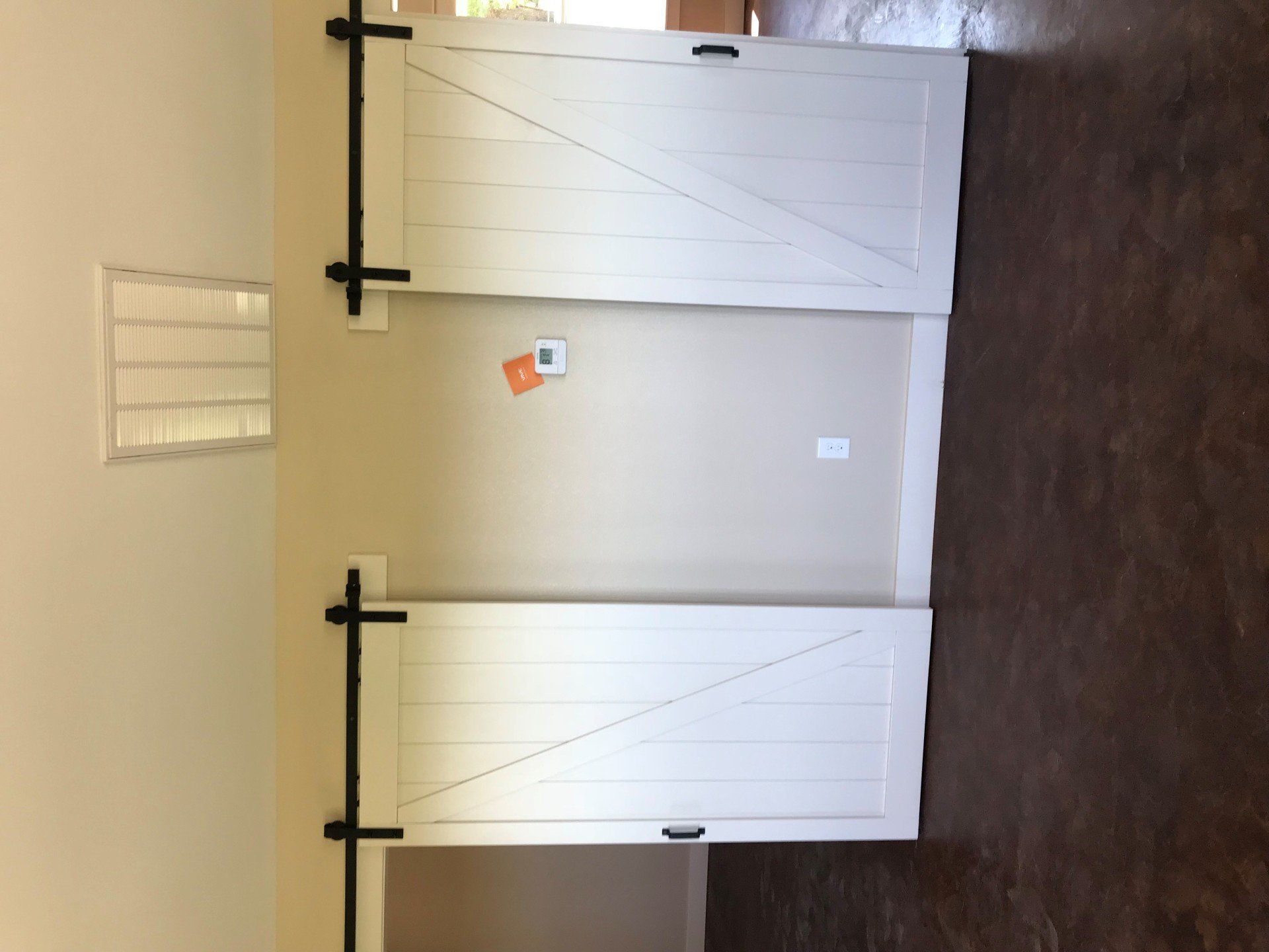 A pair of sliding barn doors in an empty room