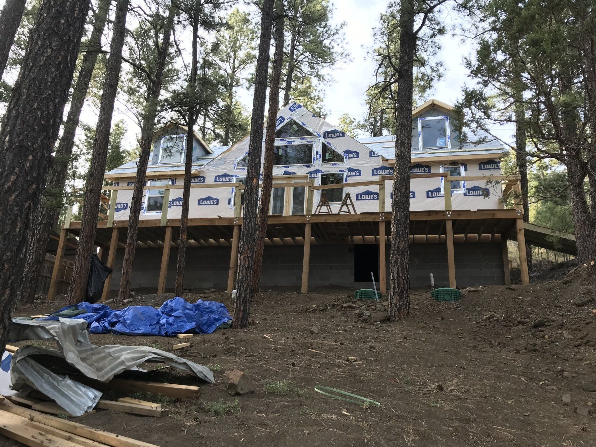 A large house is being built in the middle of a forest