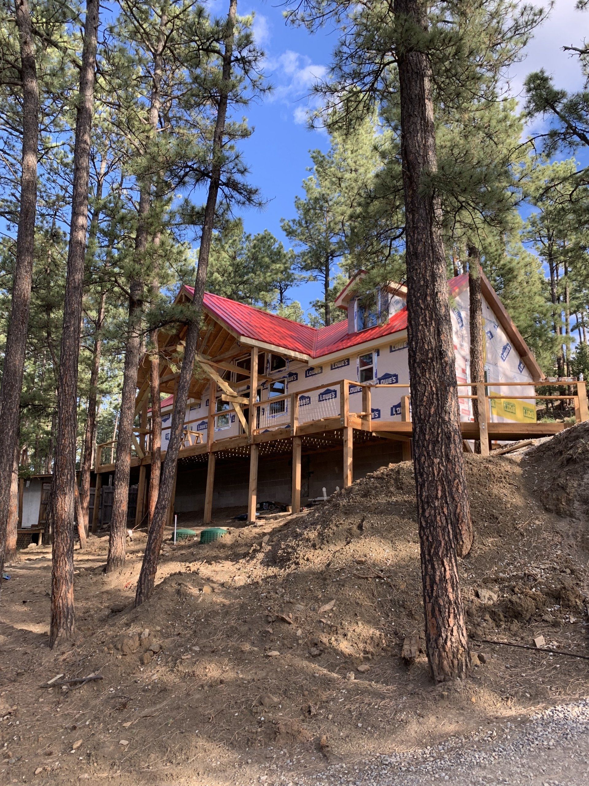 A house with a red roof is surrounded by trees.
