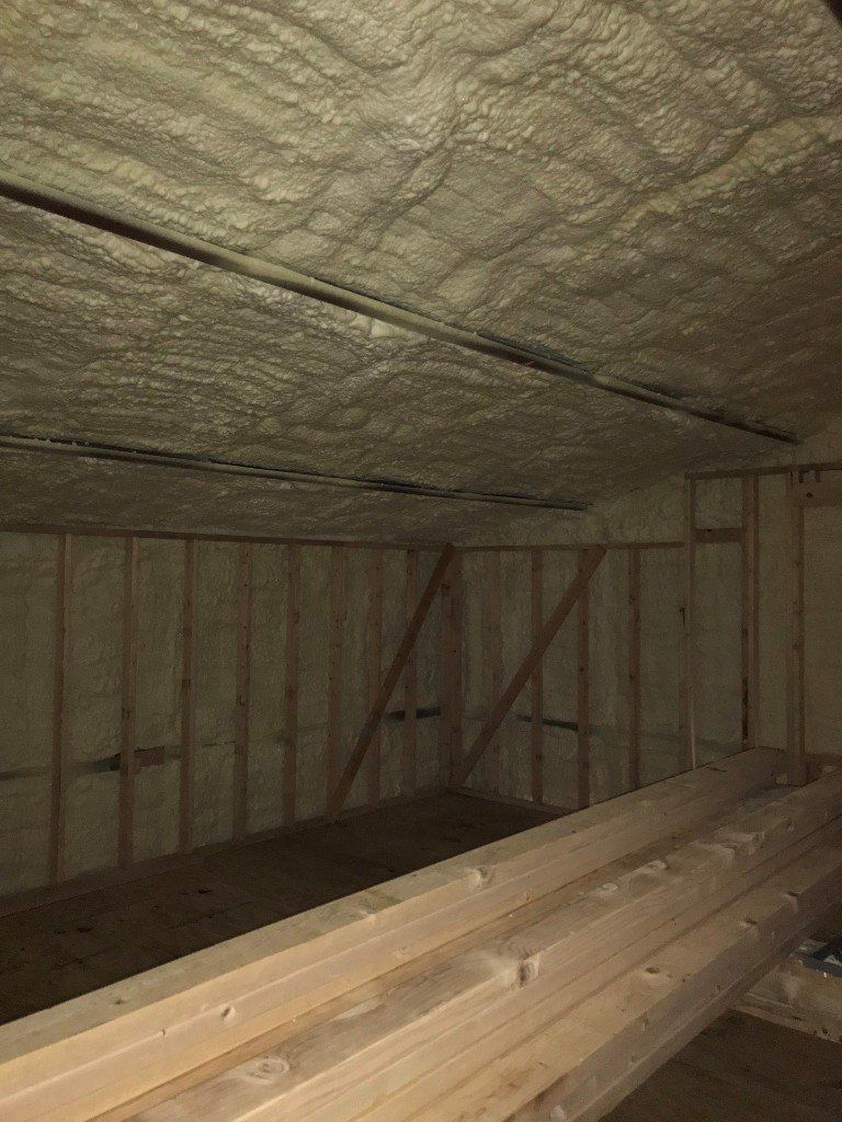 A room with a lot of wood and foam on the ceiling.