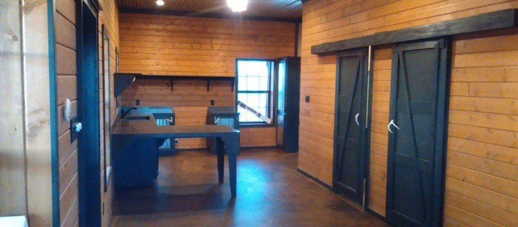 A long hallway in a wooden house with sliding doors and a table.