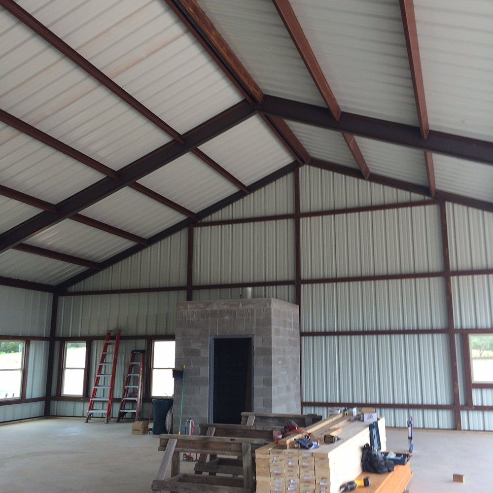 A large room with a ladder and boxes on the floor