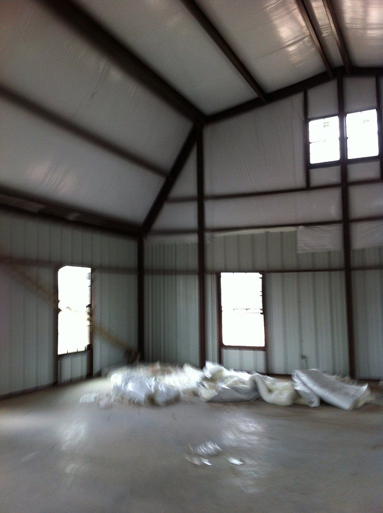 A large empty room with a lot of windows