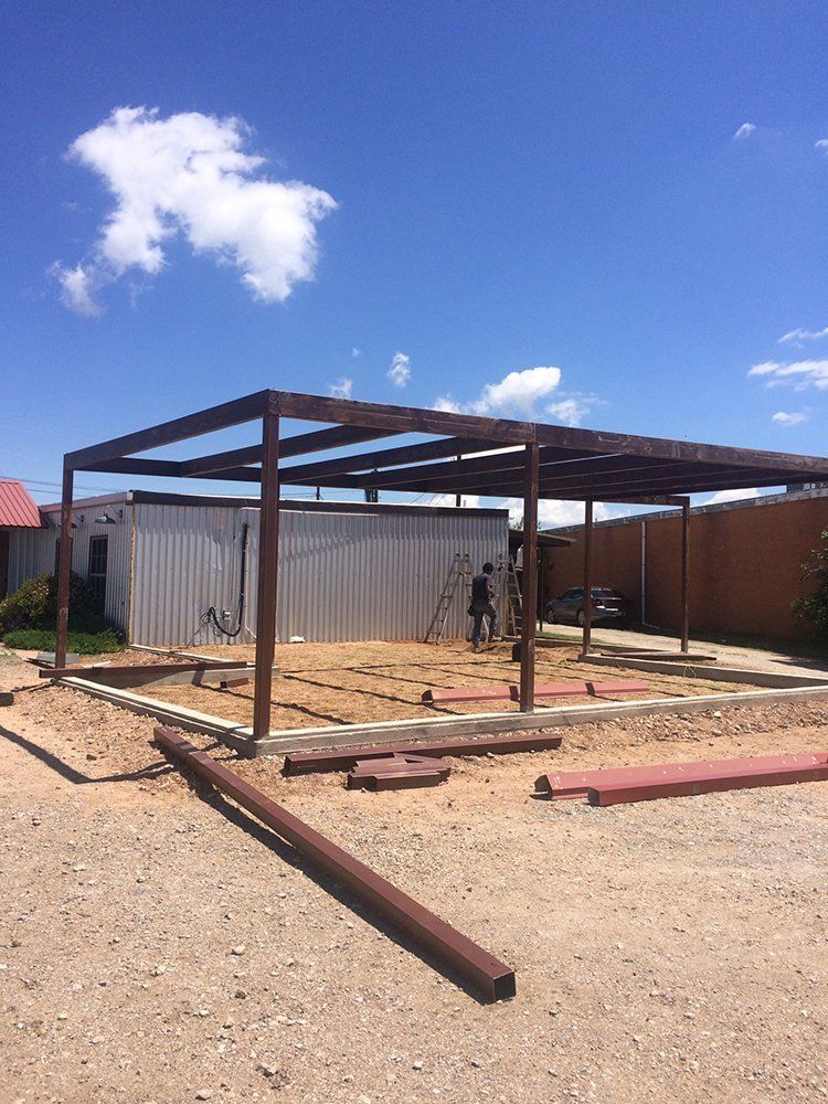A man is standing in front of a building under construction.