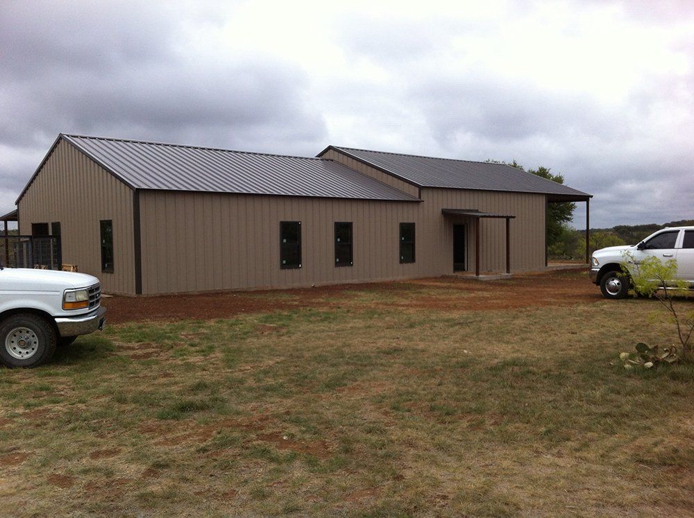 A white truck is parked in front of a large building