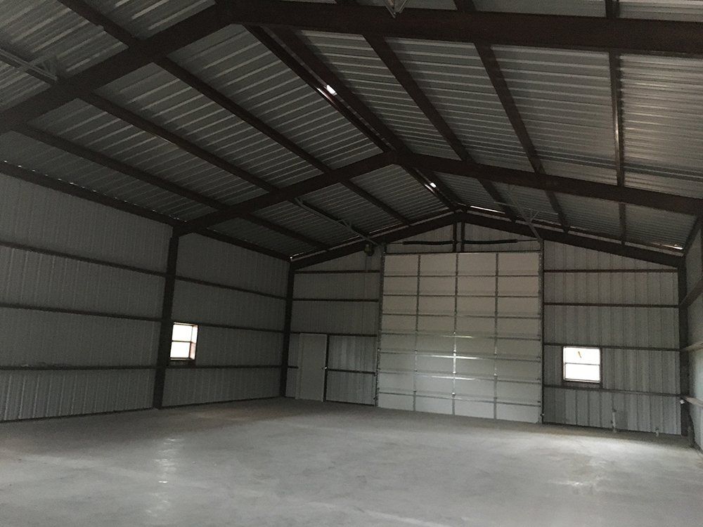 A large empty warehouse with a large garage door
