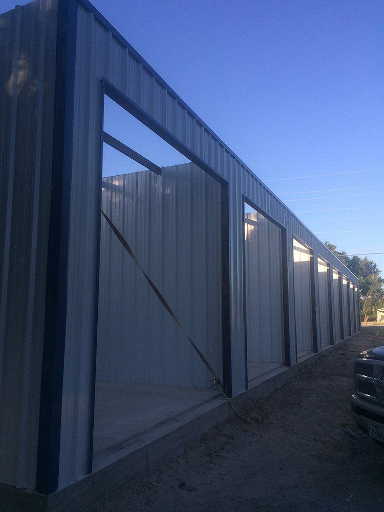 A large metal building with a blue sky in the background