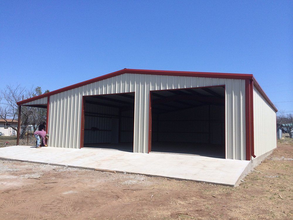 A large metal building with a red roof