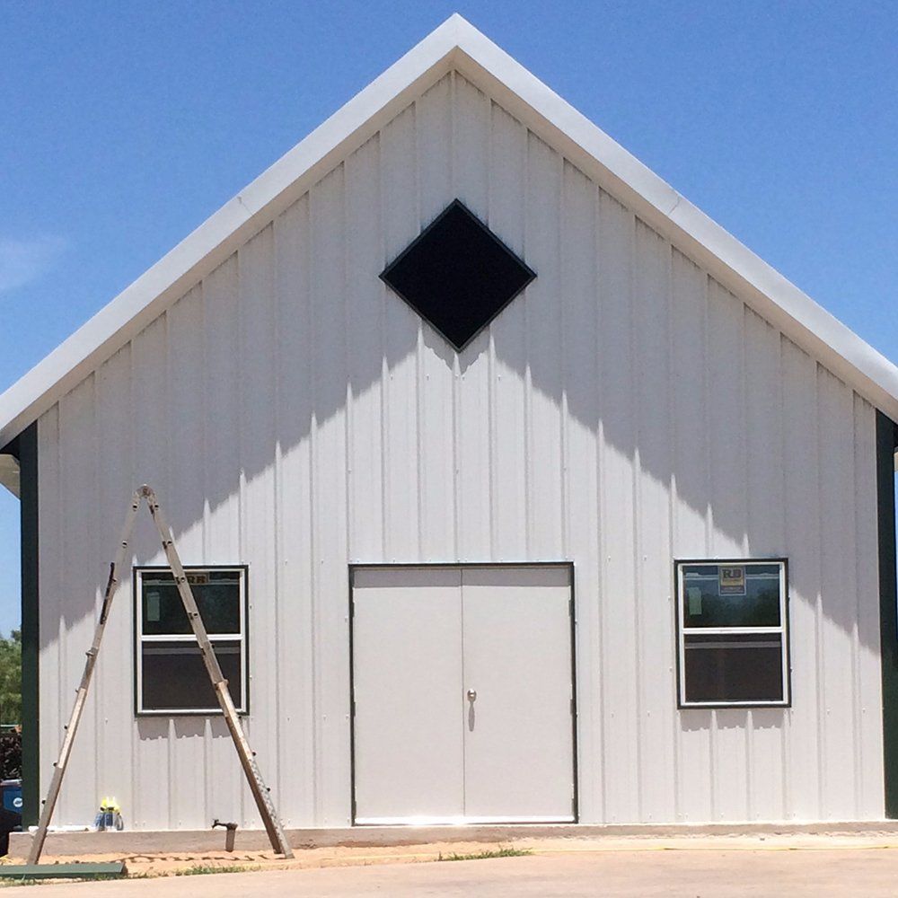 A white building with a black diamond on the roof