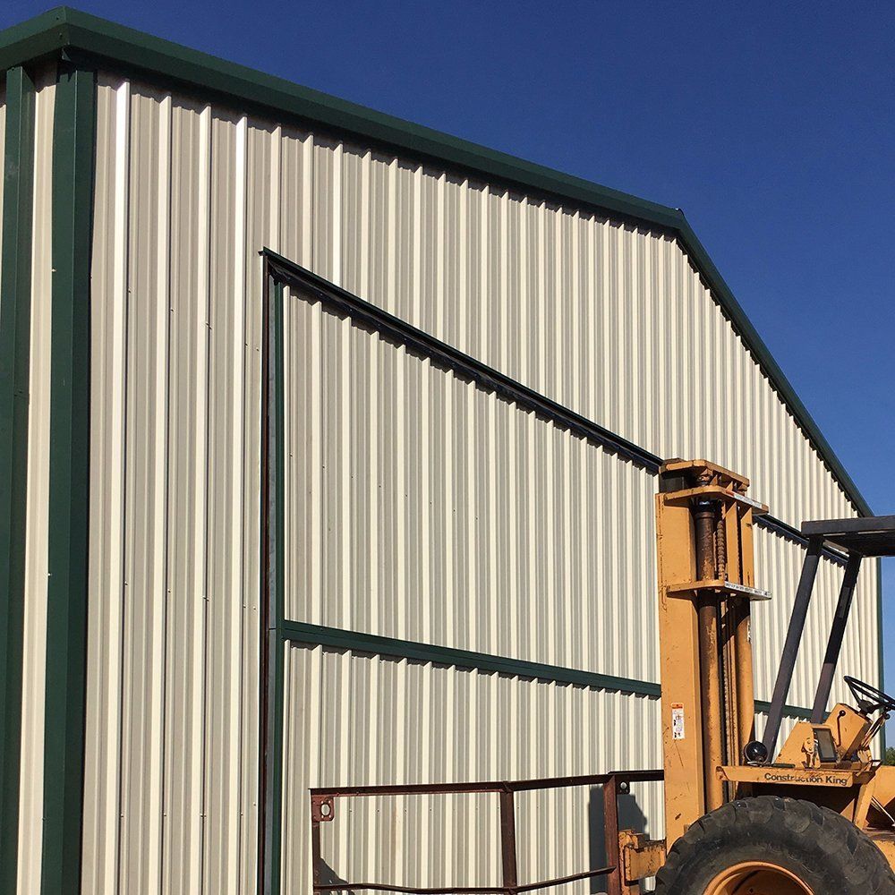A yellow forklift is parked in front of a building