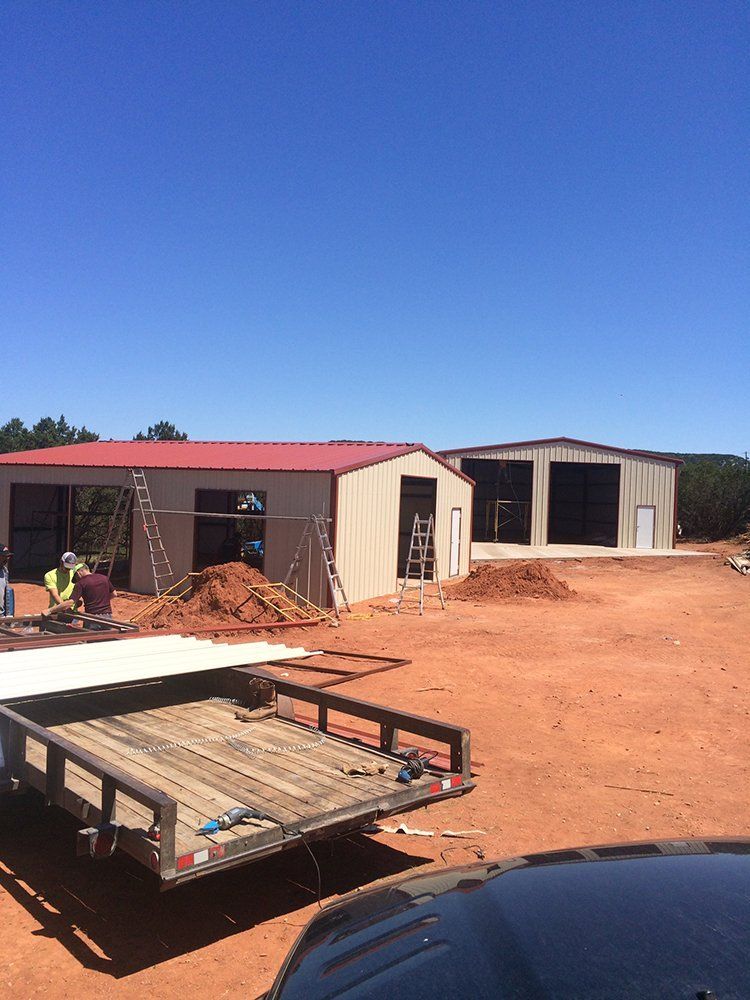 A trailer is parked in front of a building under construction.