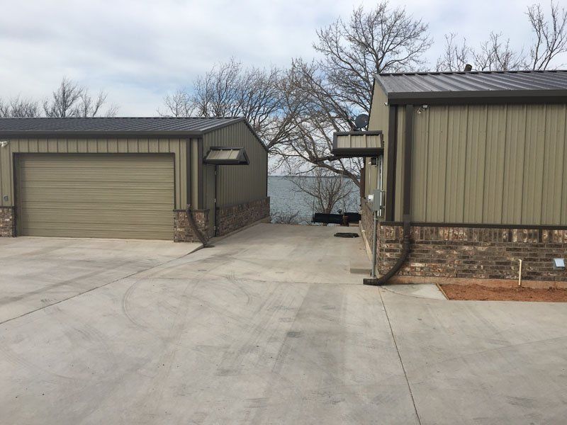 Two garages are next to each other in a driveway.