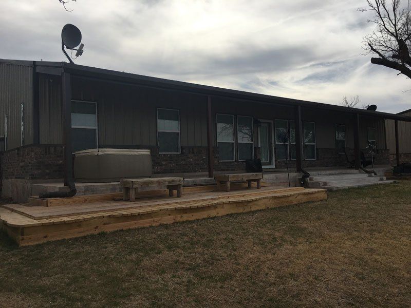 A large house with a large deck in front of it.