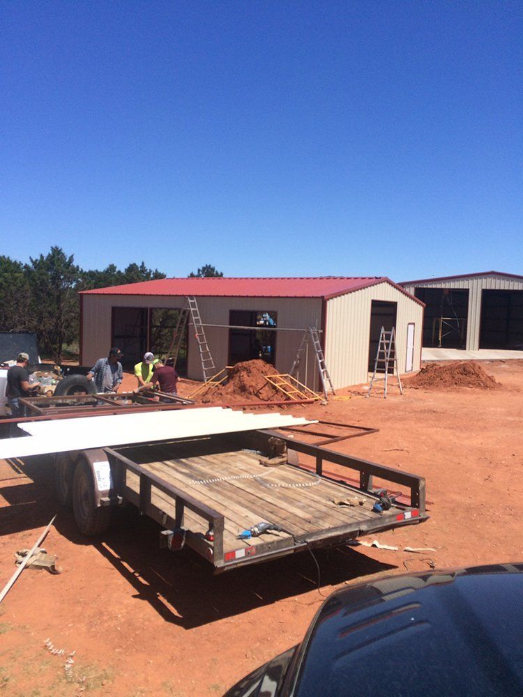 A trailer is parked in front of a building under construction.