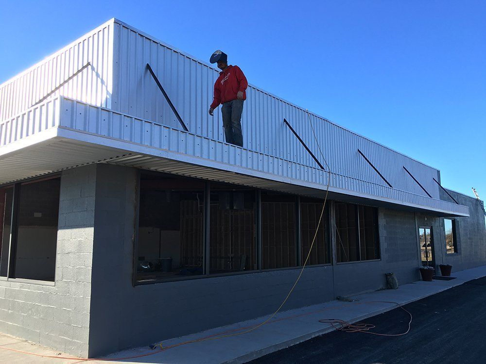 A man is standing on the roof of a building.