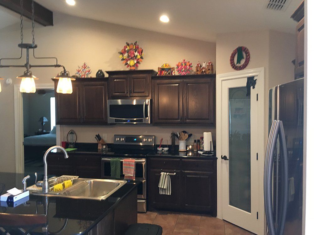 A kitchen with brown cabinets and stainless steel appliances