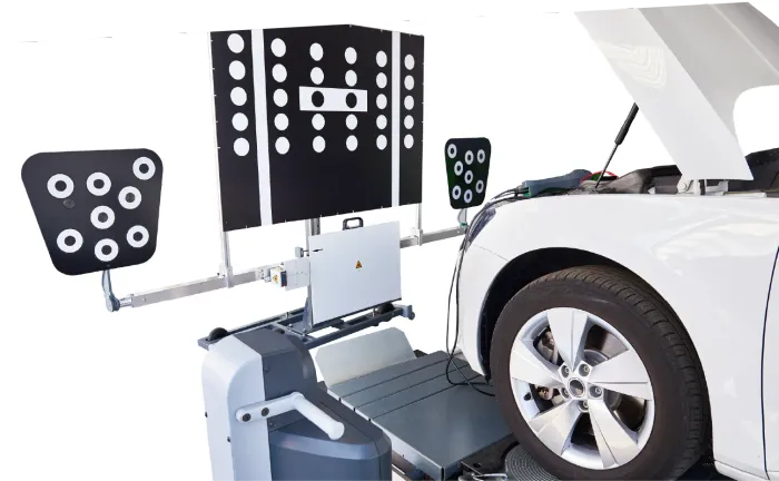 Electrician inspecting electrical panel, holding tablet, wearing hard hat and safety glasses.