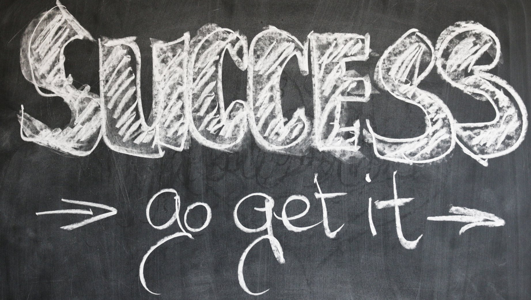A blackboard with the words success go get it written on it