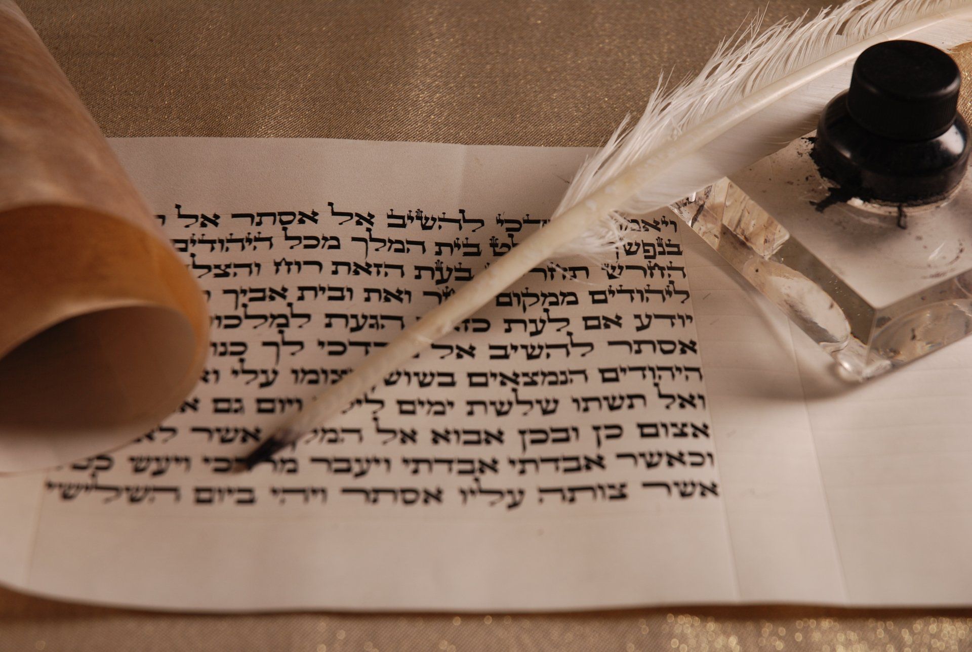 A feather pen is being used to write on a piece of paper