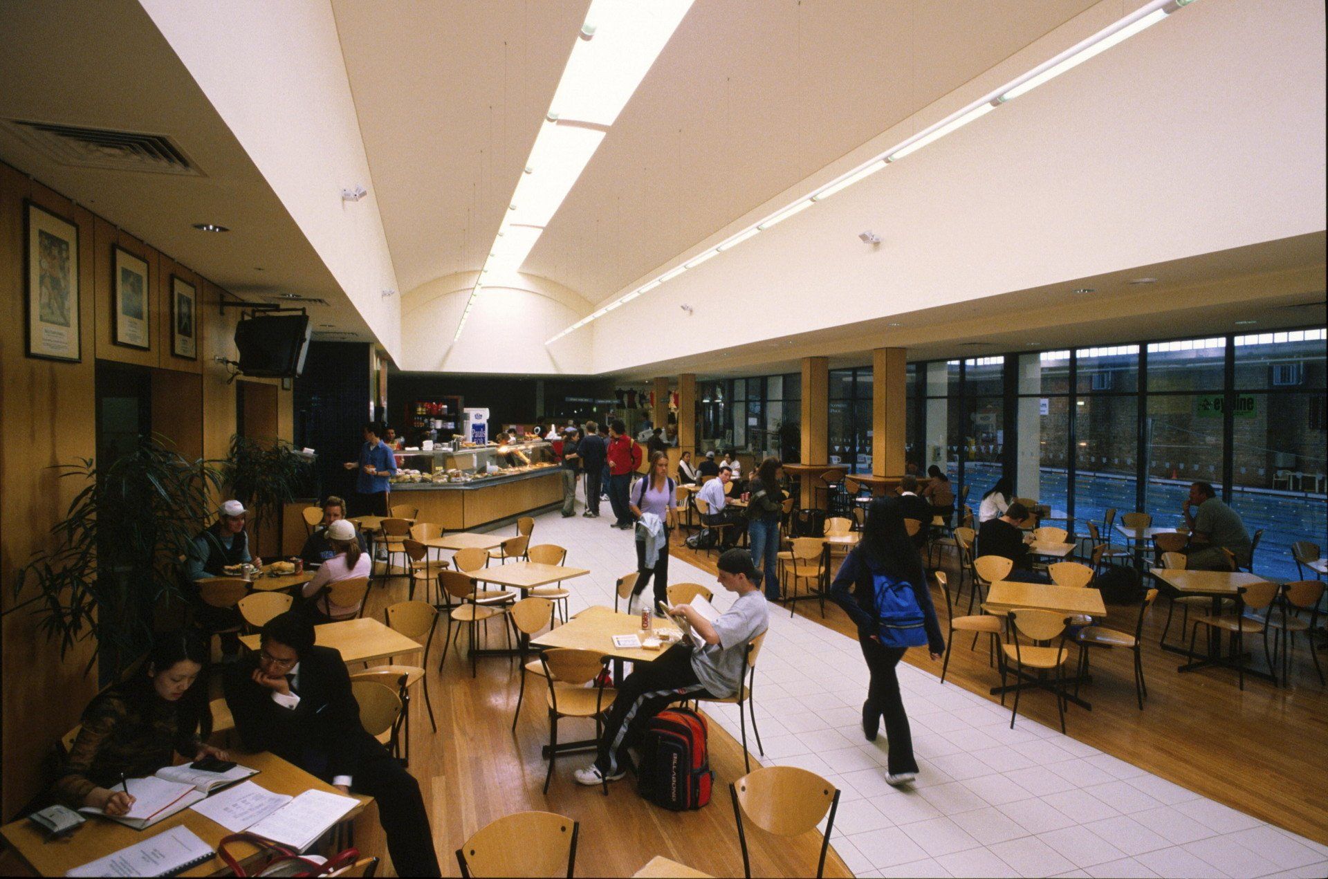 A group of people are sitting at tables in a restaurant