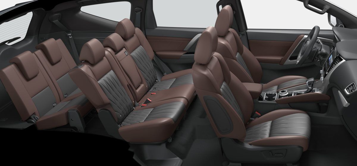 Brown leather interior of a car, showing multiple rows of seats.