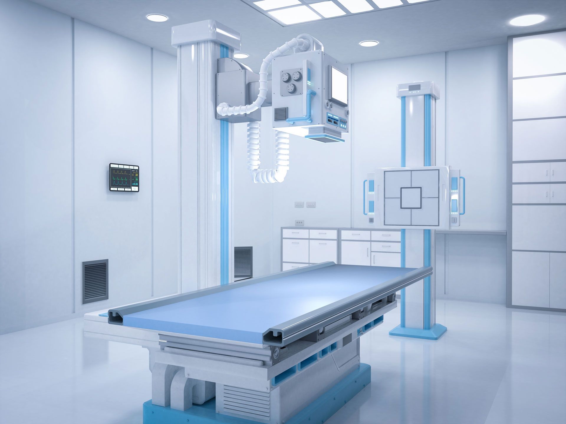 X-ray room with blue and white equipment and examination table.
