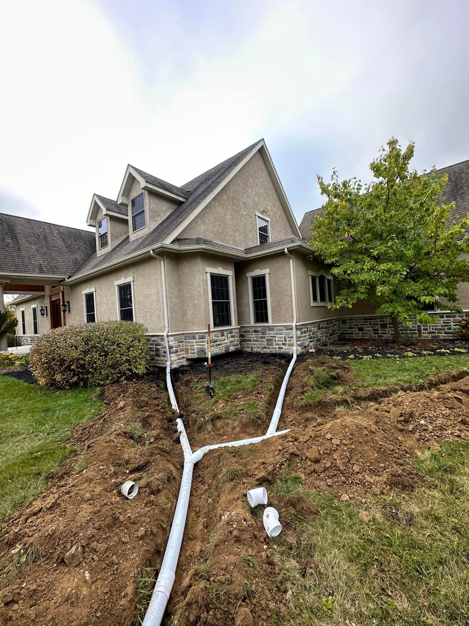 A large house with a drain pipe in front of it.