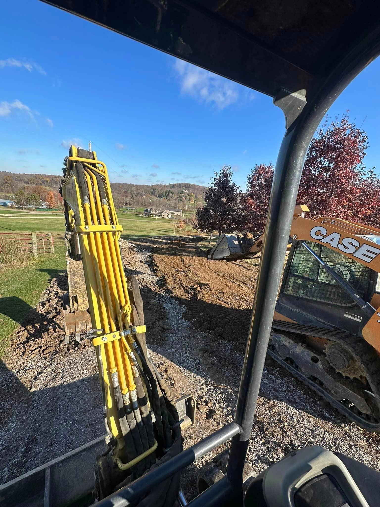 a person is driving a bulldozer on a dirt road .