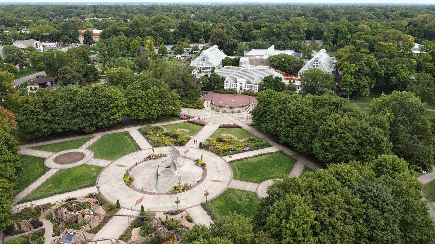 An aerial view of a park filled with lots of trees and buildings.