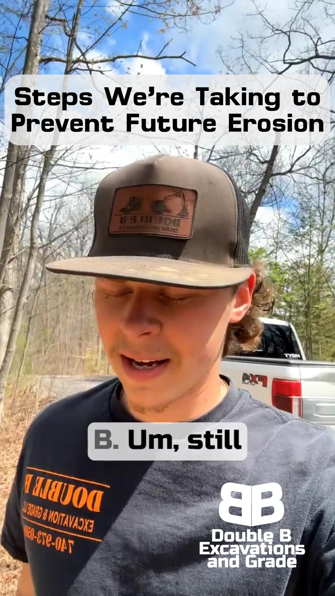 A man wearing a hat and a t-shirt is standing in front of a truck.