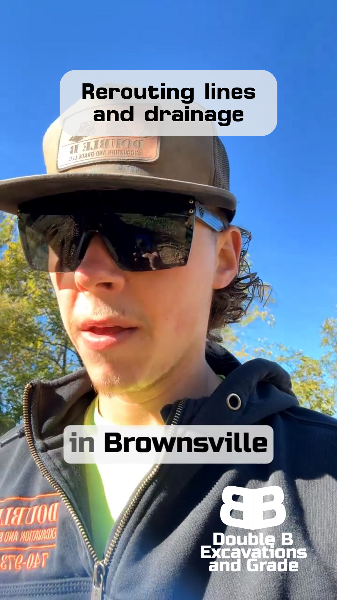 Man in sunglasses in Brownsville rerouting lines and drainage. Wearing hat, sweatshirt with Double B logo.