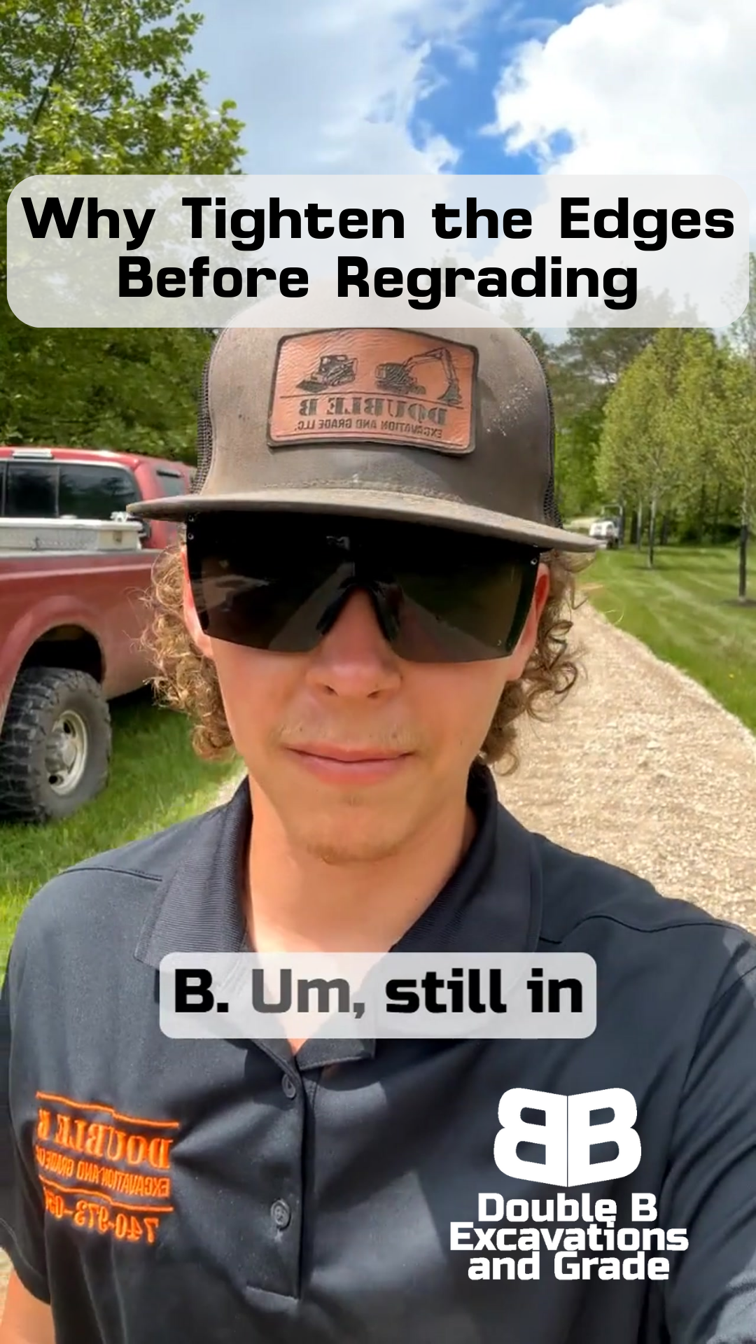 A man wearing a hat and sunglasses is standing on a gravel road.