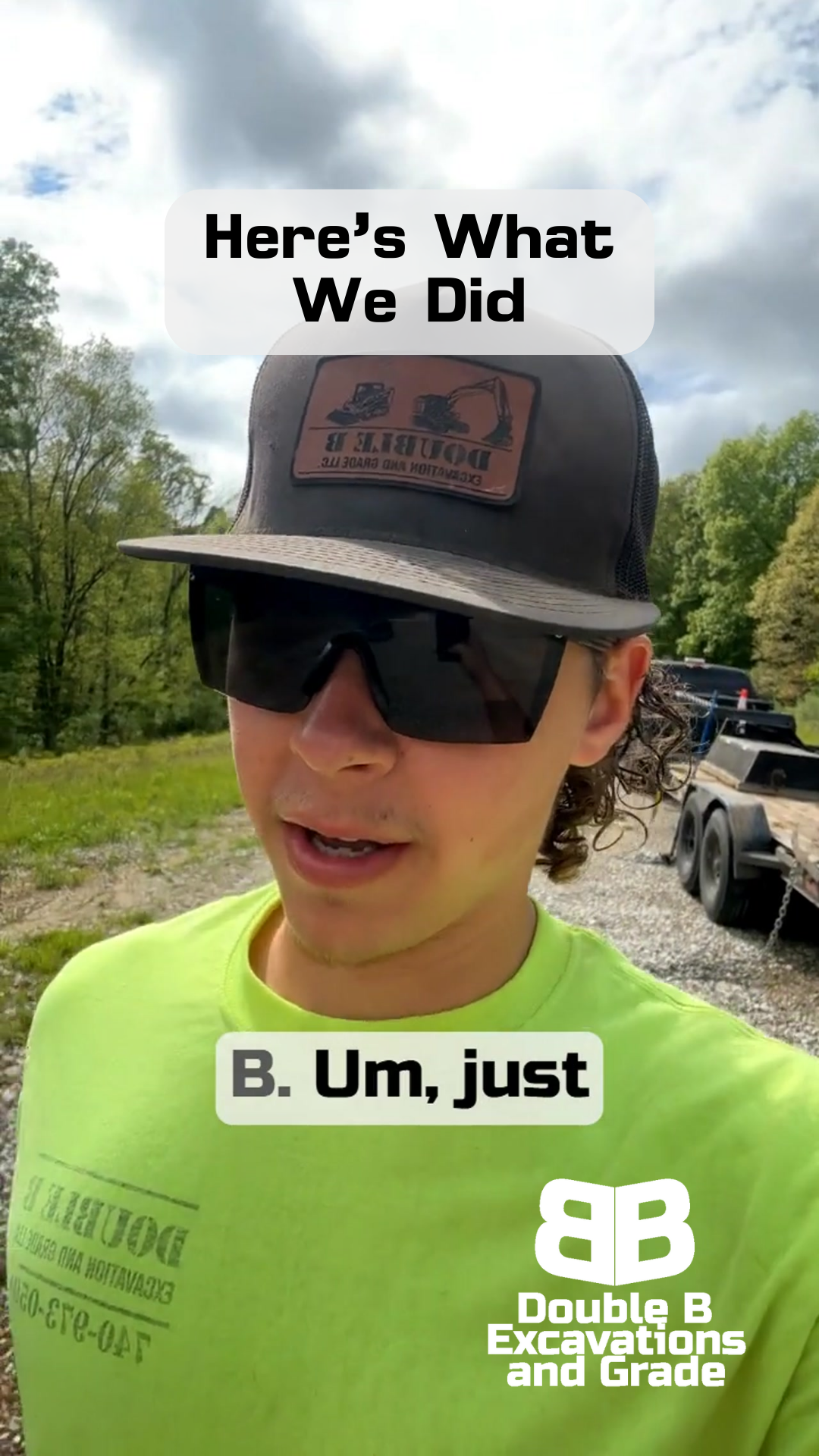 A man wearing a hat and sunglasses is standing in a field.