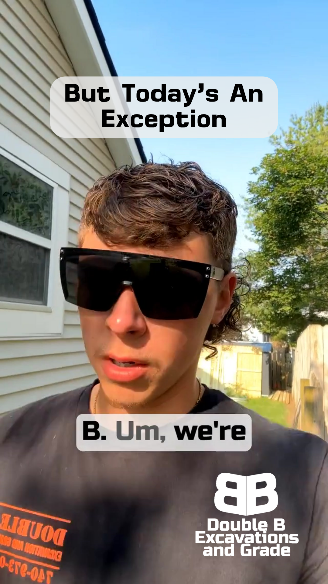 A man wearing sunglasses is standing in front of a house.