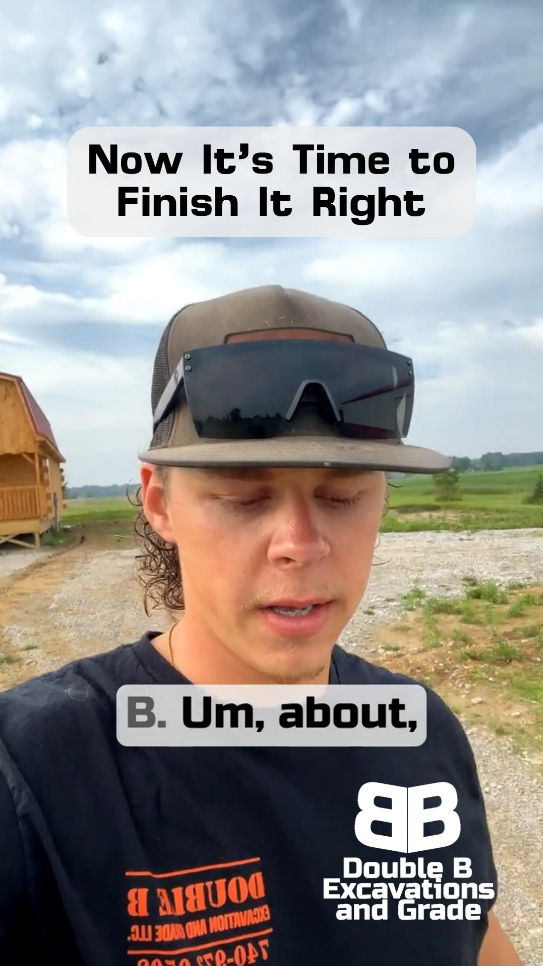 A man wearing a hat and sunglasses is standing on a dirt road.