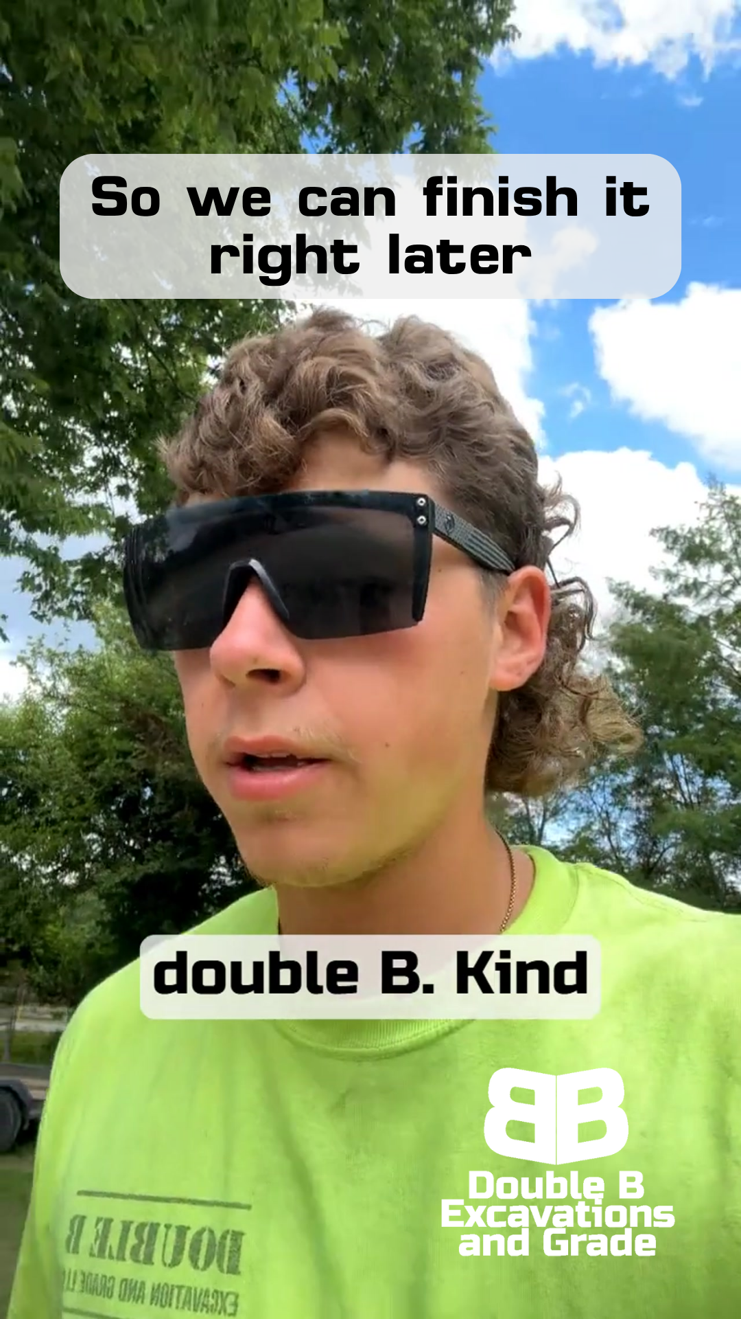 A young man wearing sunglasses and a green shirt.