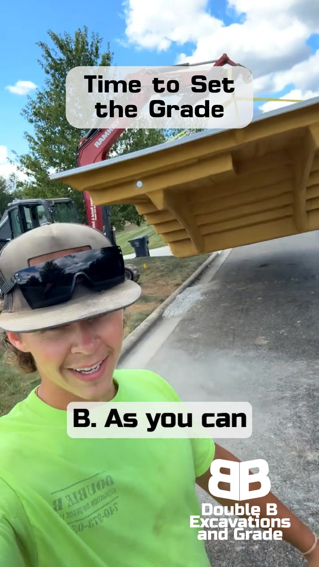 Man in neon shirt and hat smiles; excavating a wooden structure with a machine in a sunny setting.