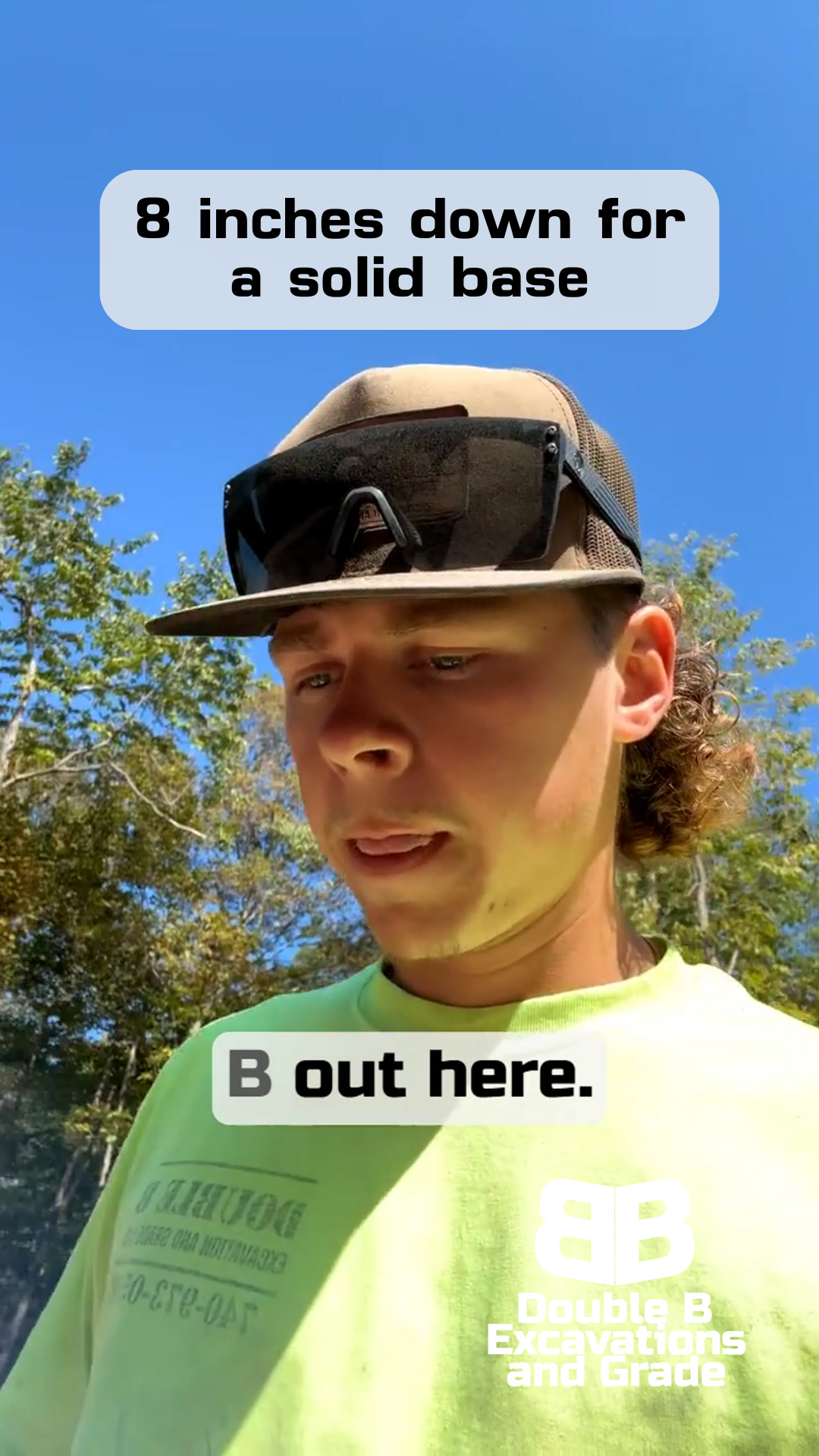 A man in a hat and sunglasses, discussing 8 inches down for a solid base, outdoors.