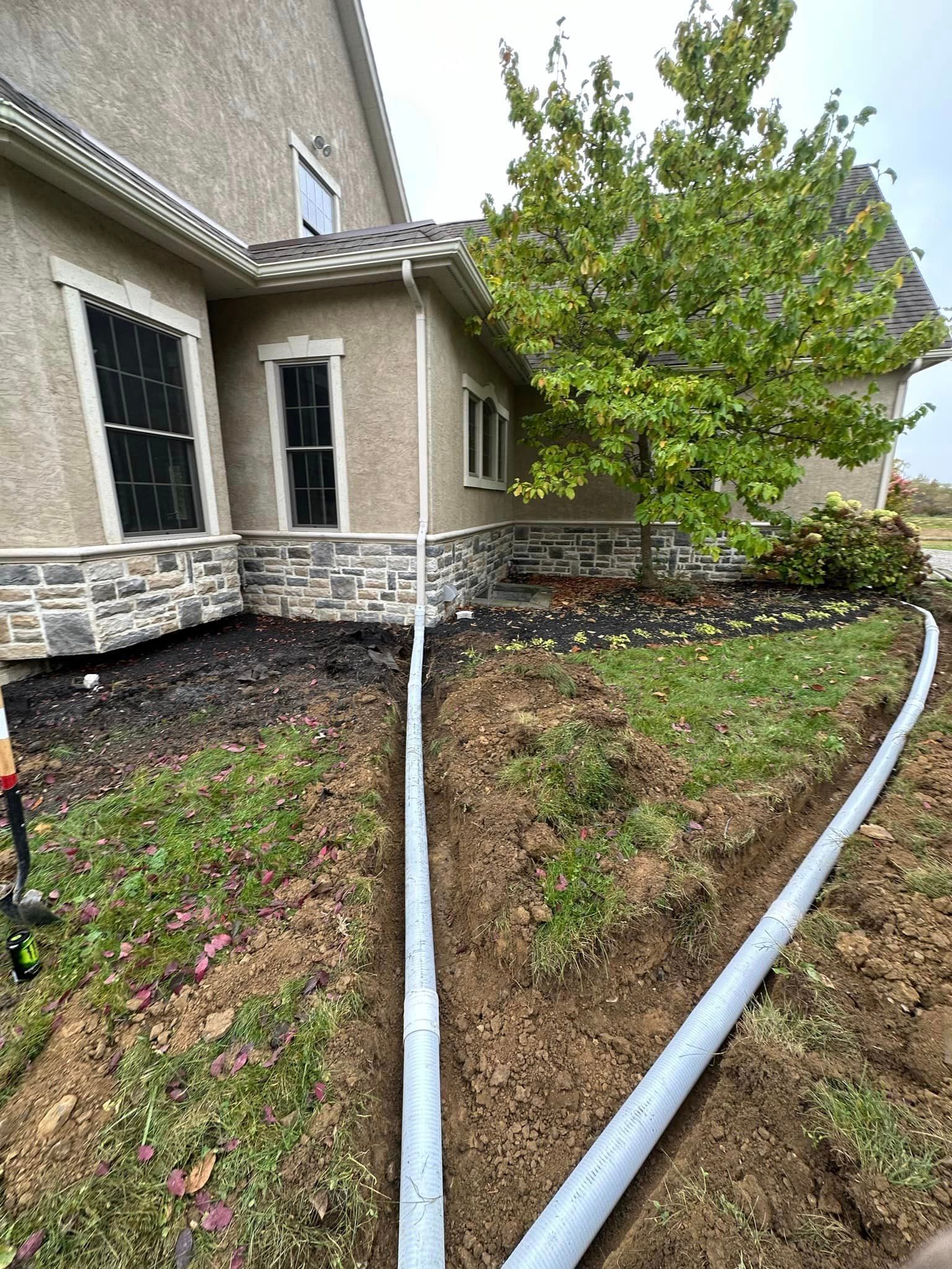 A hose is being installed in front of a house.