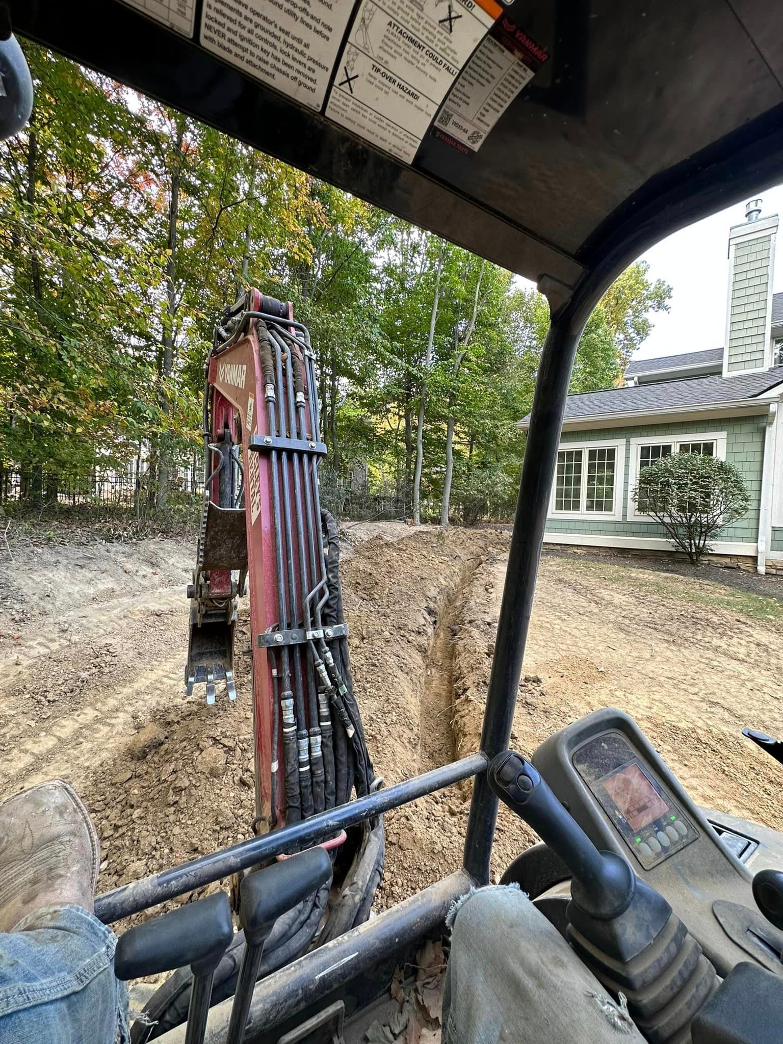 A person is driving a bulldozer on a dirt road.