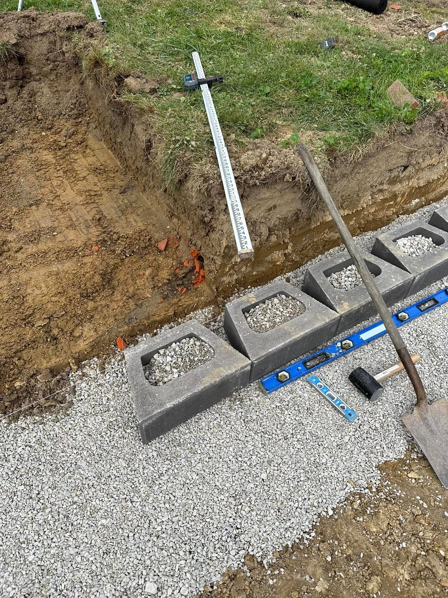 A shovel is laying on top of a pile of gravel.