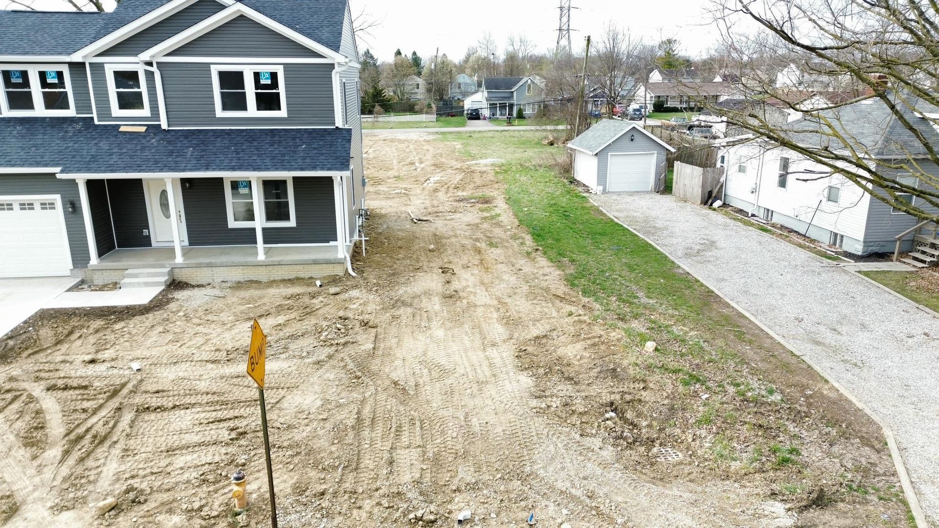 An aerial view of a house and a dirt road.