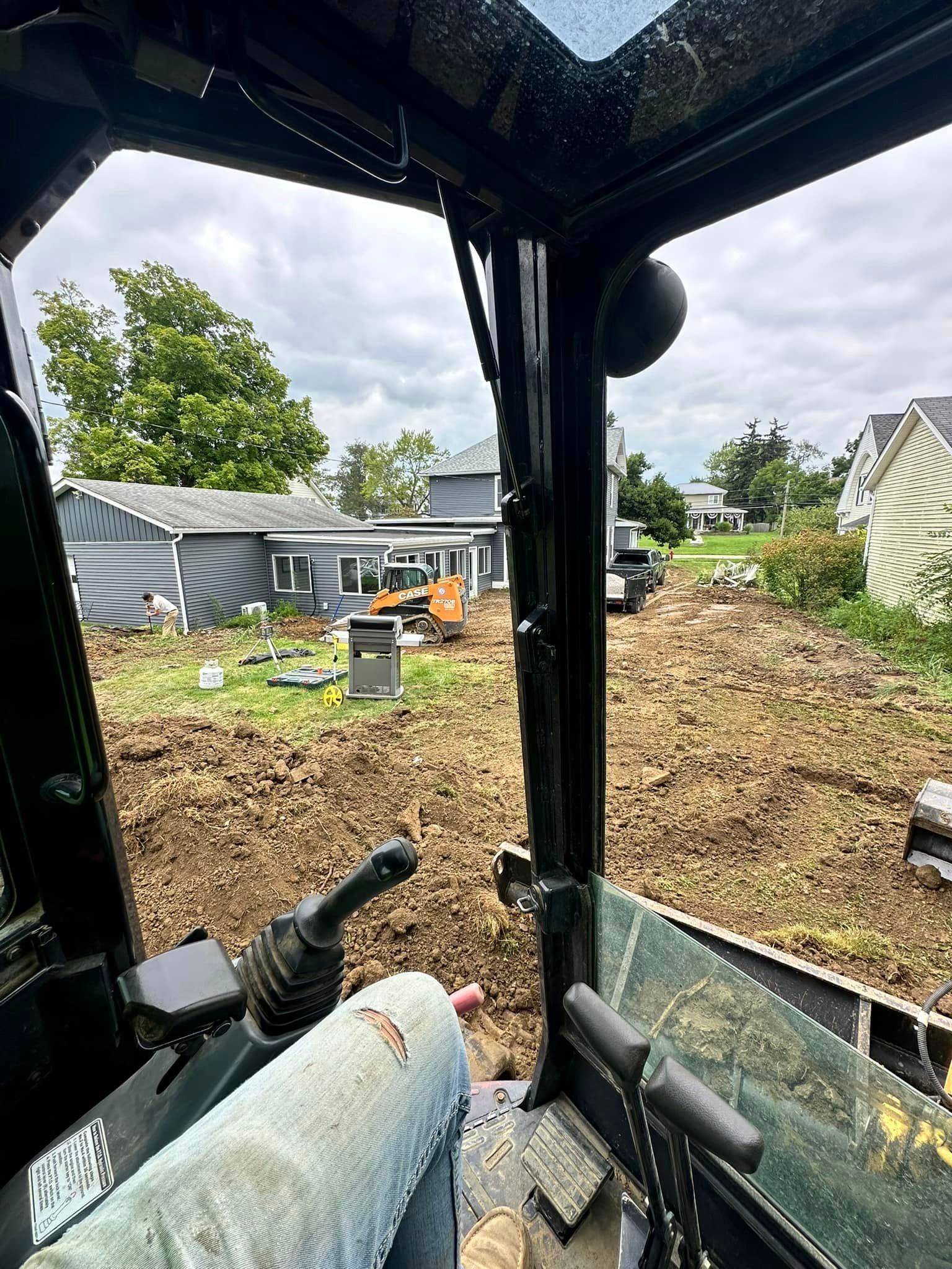 A person is sitting in the driver 's seat of a bulldozer.