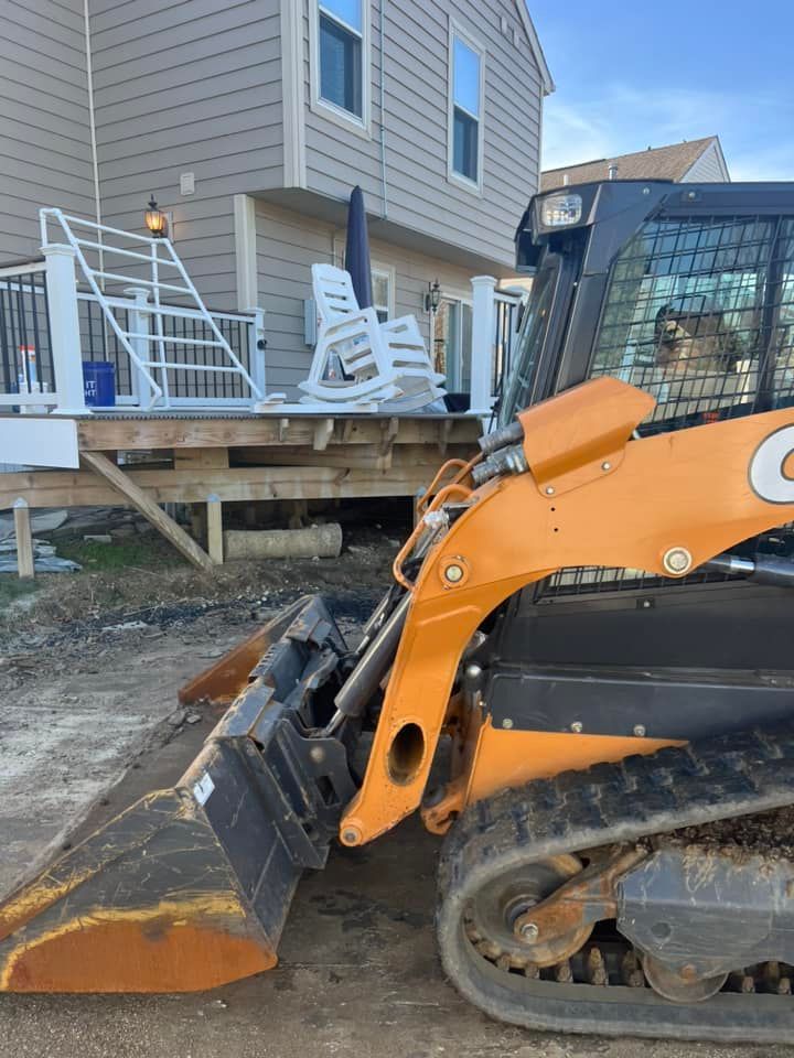 A bulldozer is parked in front of a house.